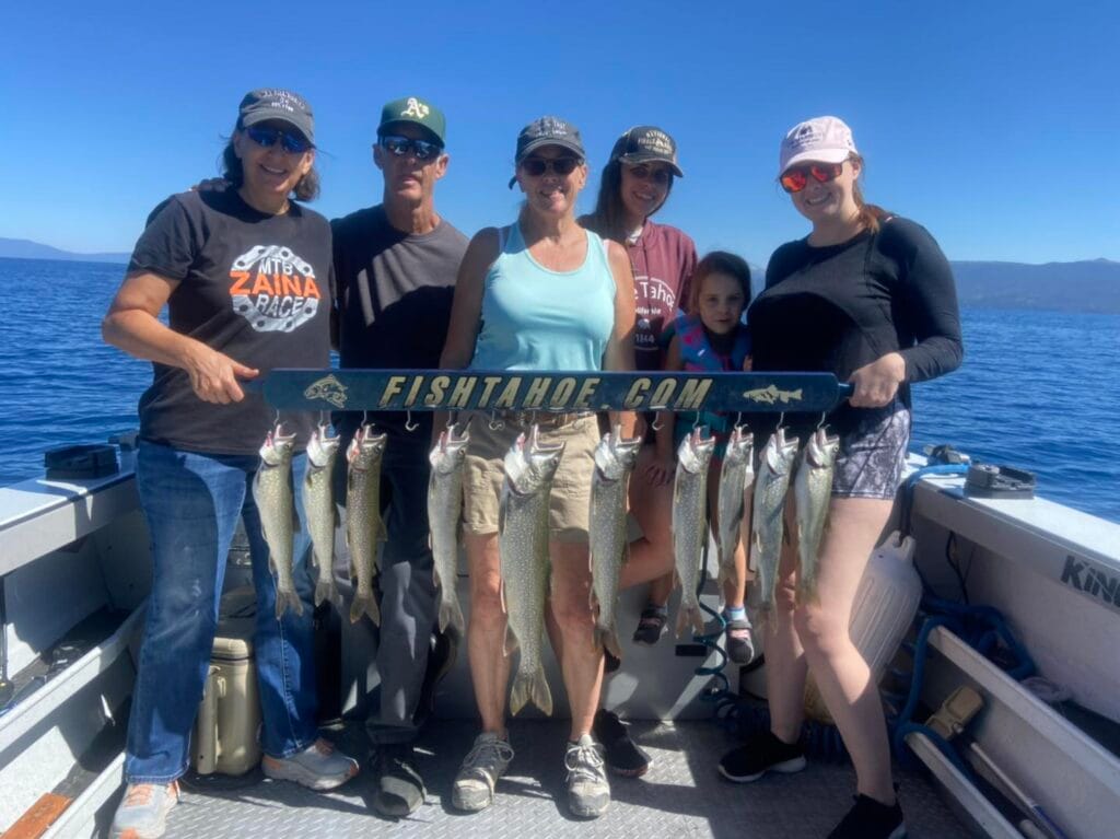Family holding a full rack of Lake Trout aboard FishTahoe.com charter boat