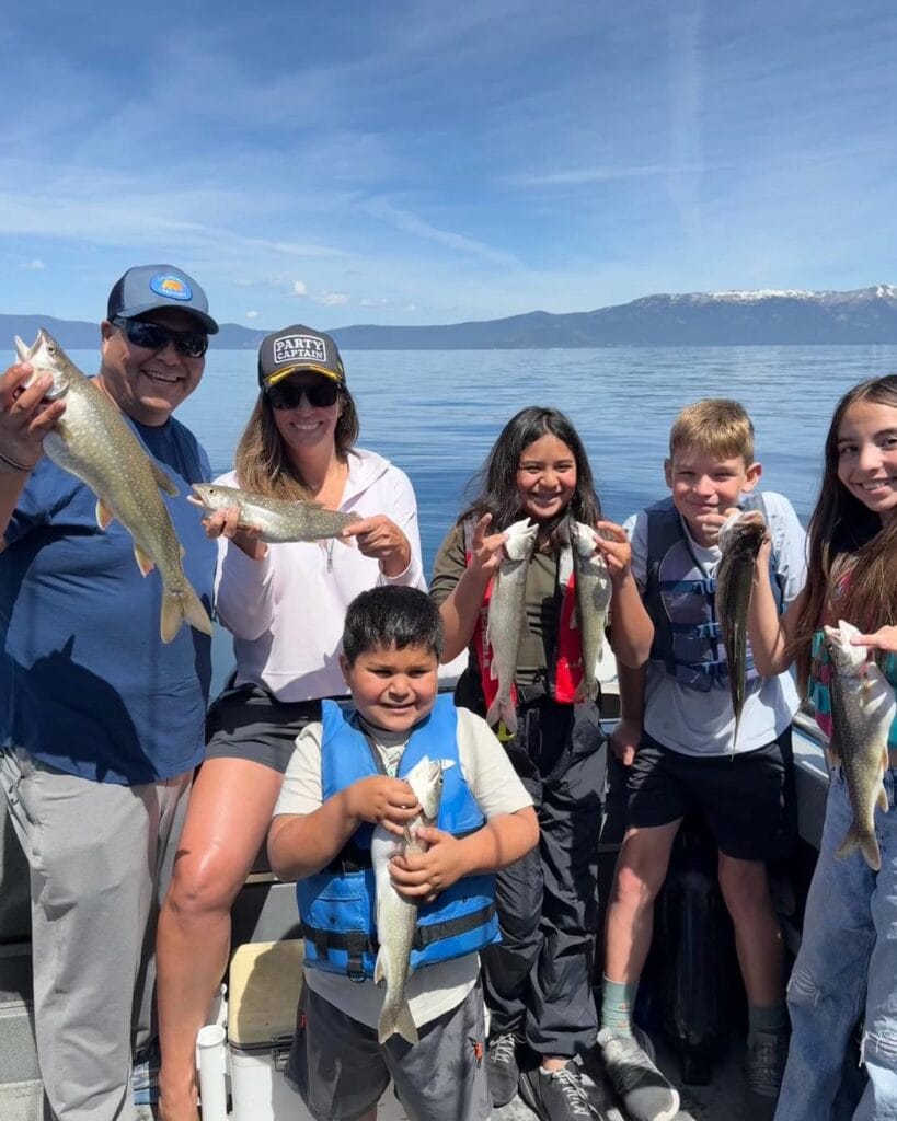 Kids and adults with trout catches on a Lake Tahoe family fishing trip