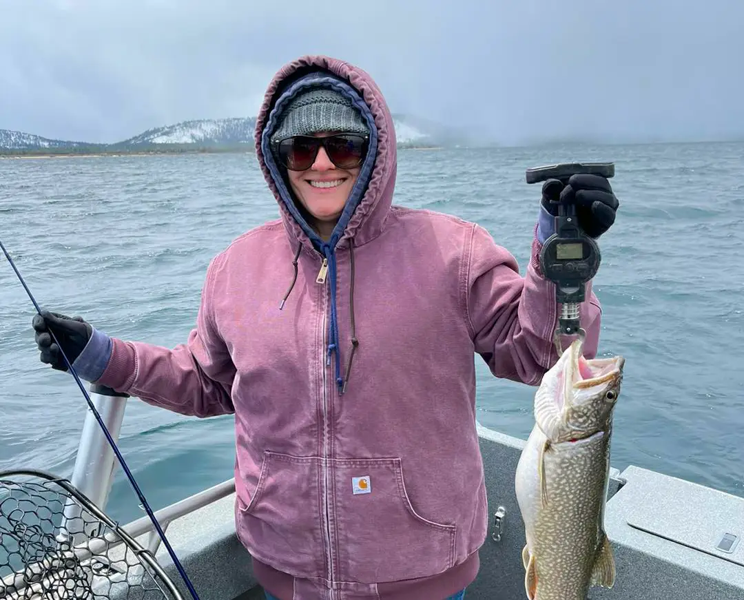 Mile High Fishing Charters client holding a Lake Tahoe Mackinaw trout on a winter fishing charter, South Lake Tahoe