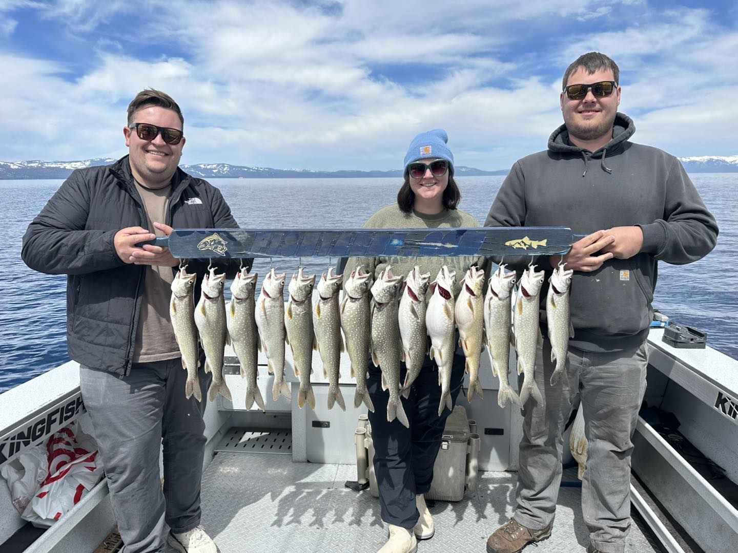 Group of anglers holding a stringer of mackinaw trout